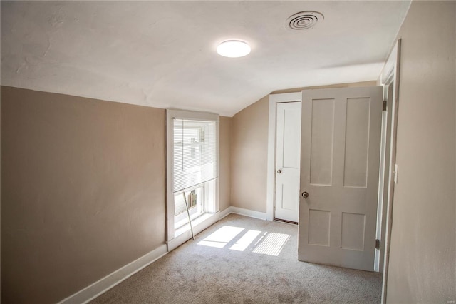 additional living space with light carpet and lofted ceiling