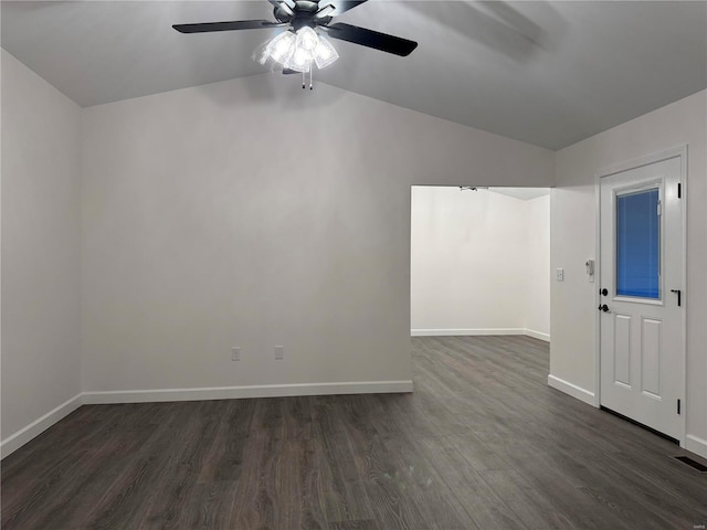 empty room with lofted ceiling, ceiling fan, and dark hardwood / wood-style floors