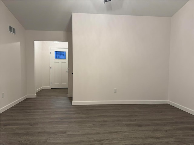 empty room with dark hardwood / wood-style floors