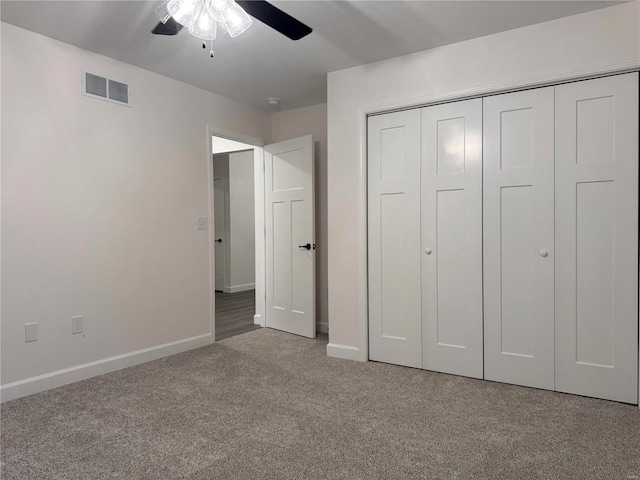 unfurnished bedroom with carpet, a closet, and ceiling fan