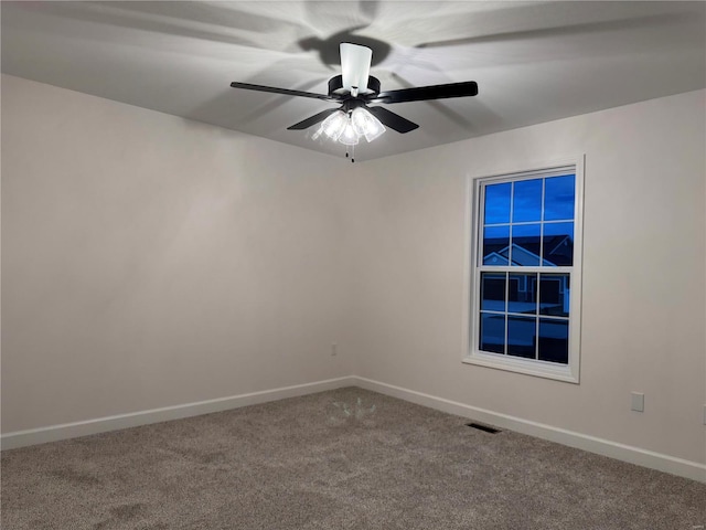 carpeted spare room with ceiling fan