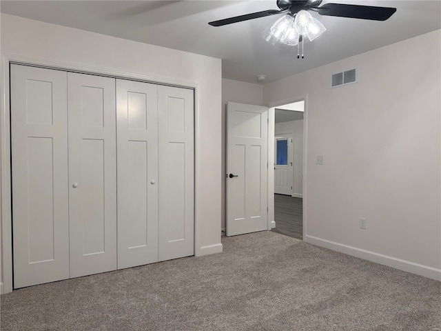 unfurnished bedroom featuring ceiling fan, light carpet, and a closet