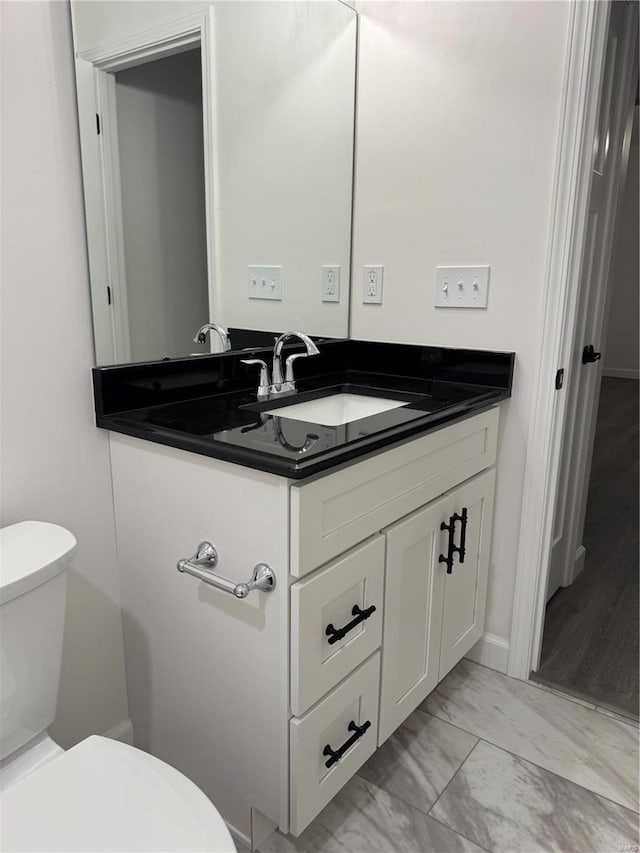 bathroom with vanity and toilet