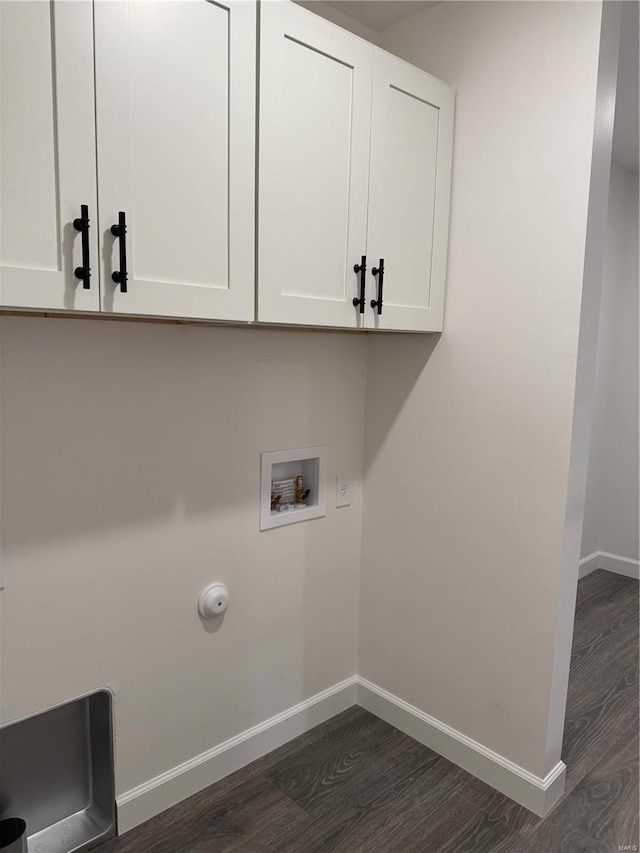 laundry room featuring cabinets, hookup for a washing machine, dark wood-type flooring, and gas dryer hookup