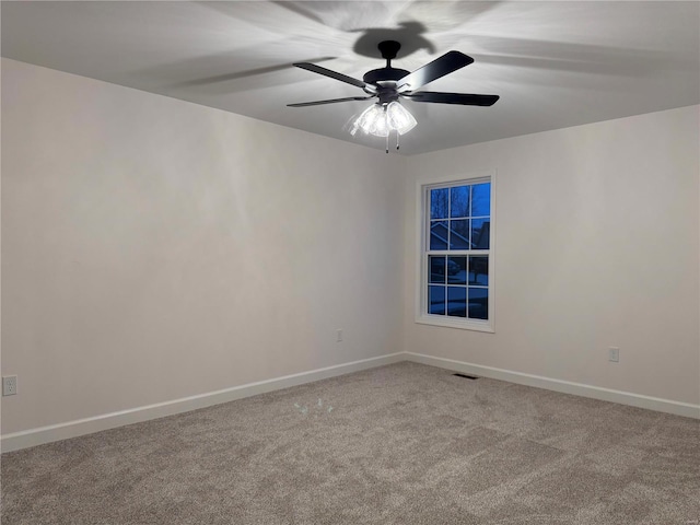 carpeted empty room featuring ceiling fan