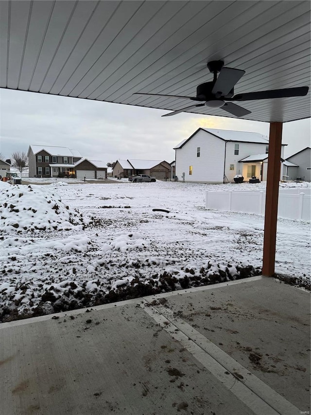 snowy yard with ceiling fan