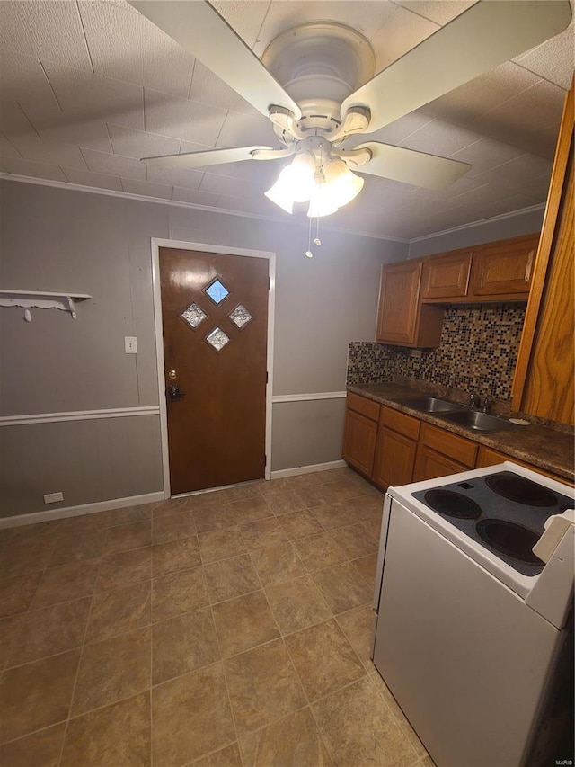 kitchen featuring tasteful backsplash, ornamental molding, white range with electric cooktop, and ceiling fan