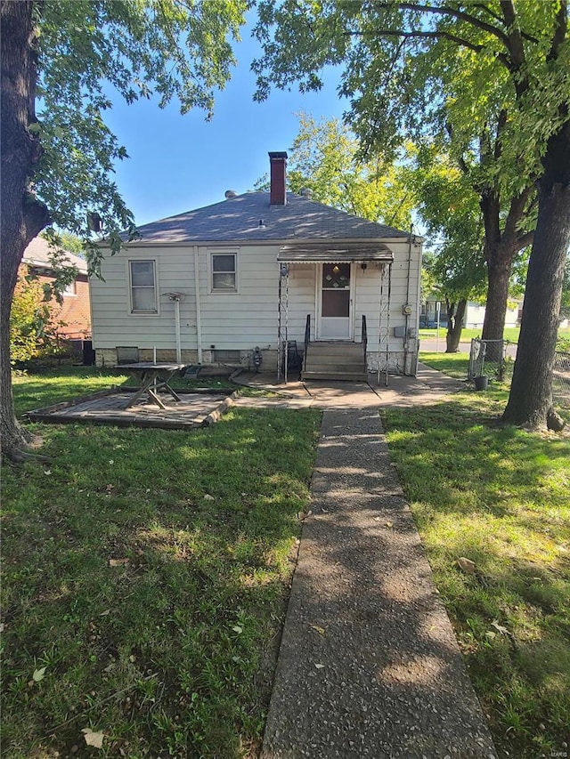 back of house with a yard and a patio area