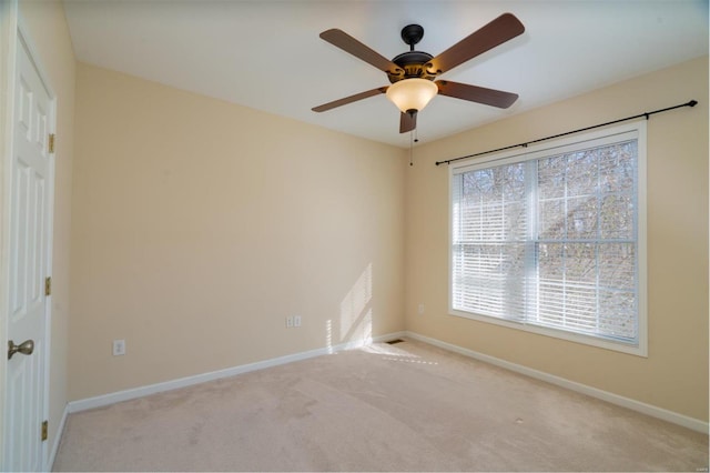 interior space with light carpet and ceiling fan