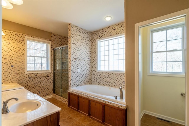 bathroom featuring shower with separate bathtub, tile patterned floors, and vanity