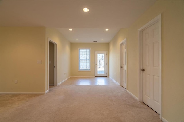 entryway featuring light colored carpet