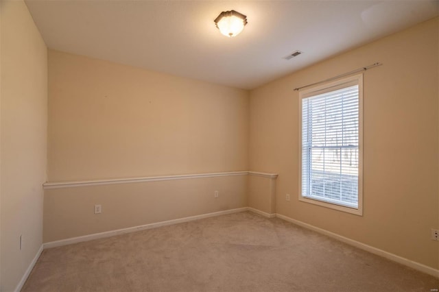 unfurnished room featuring light colored carpet