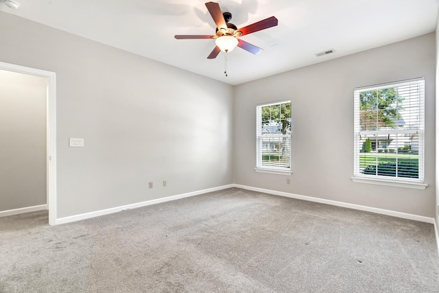 carpeted empty room featuring ceiling fan