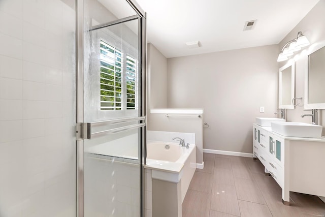 bathroom featuring tile patterned flooring, vanity, and separate shower and tub