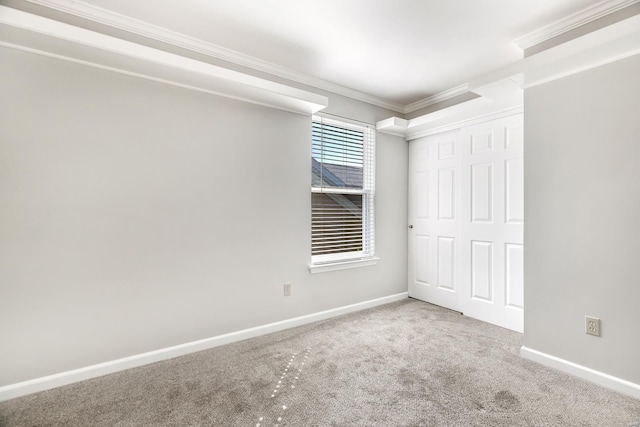 unfurnished bedroom with carpet floors, a closet, and crown molding