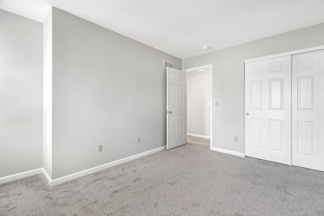 unfurnished bedroom with carpet and a closet