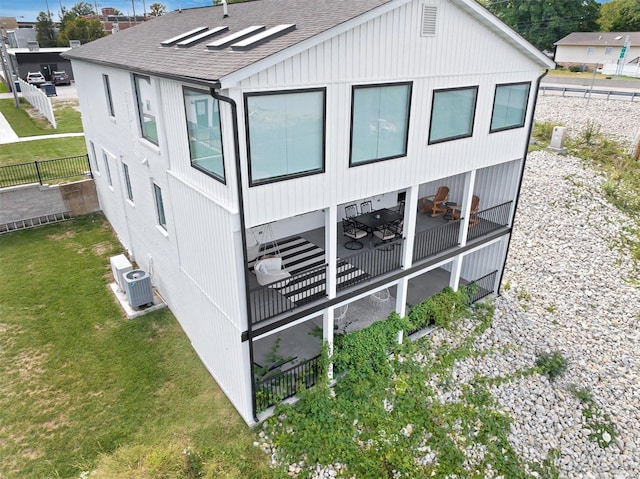 view of home's exterior with a yard and cooling unit