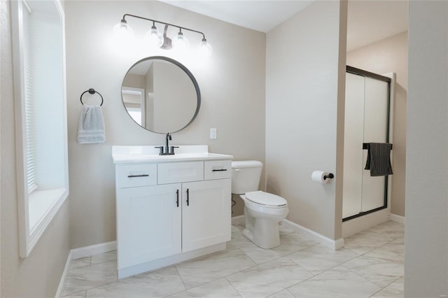 bathroom with vanity, toilet, and a shower with shower door