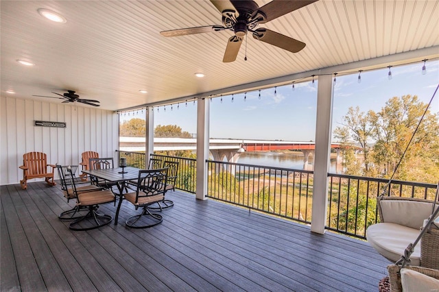 sunroom / solarium featuring a water view, ceiling fan, and wooden ceiling