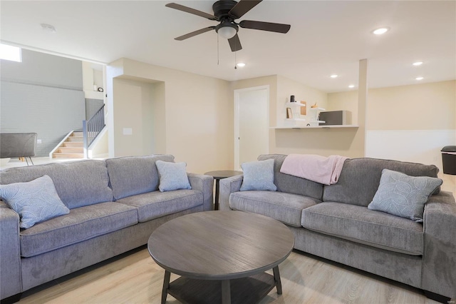 living room featuring ceiling fan and light wood-type flooring