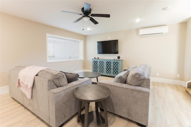 living room featuring light hardwood / wood-style floors, a wall mounted air conditioner, and ceiling fan