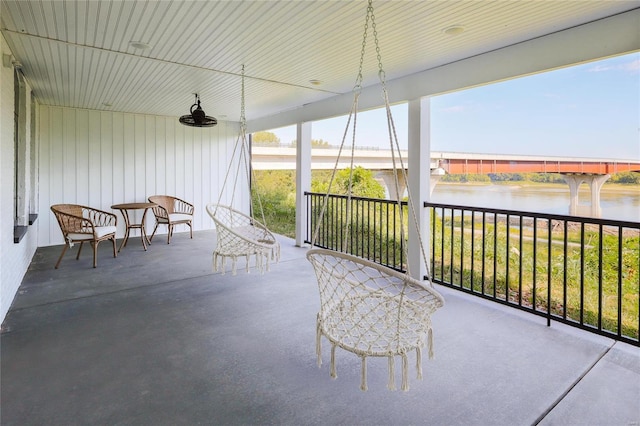 unfurnished sunroom featuring a water view