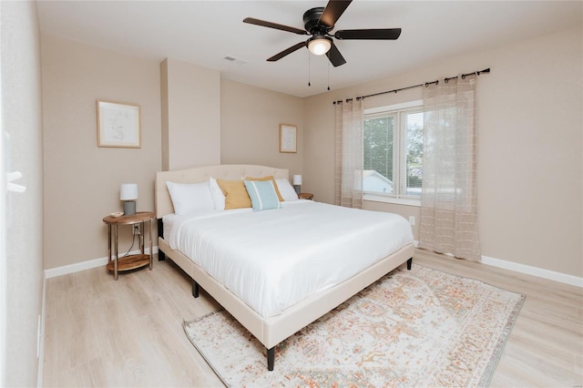 bedroom with light hardwood / wood-style floors and ceiling fan