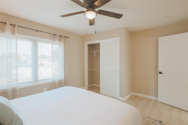 bedroom featuring light hardwood / wood-style flooring, a closet, and ceiling fan