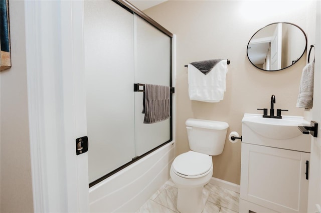 full bathroom with vanity, bath / shower combo with glass door, and toilet