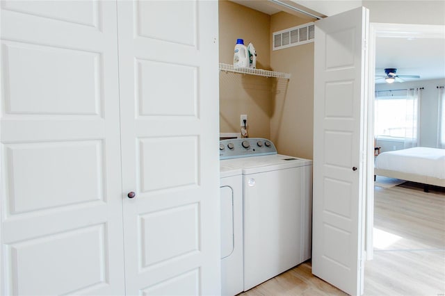 laundry room with light hardwood / wood-style flooring, separate washer and dryer, and ceiling fan