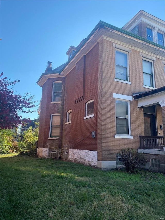 view of side of property with a yard