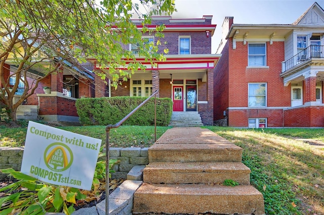 view of front of home featuring a balcony and a front lawn