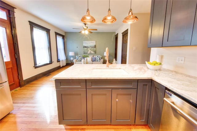 kitchen featuring light hardwood / wood-style floors, dishwasher, light stone countertops, and ceiling fan