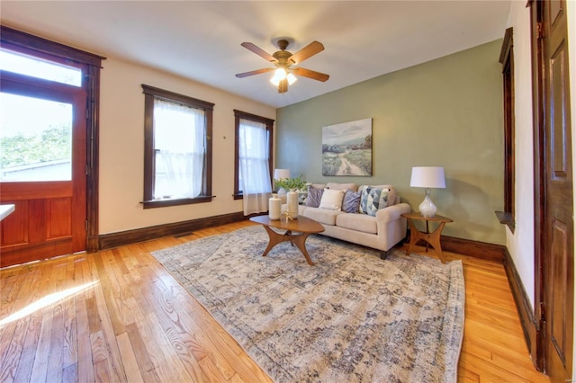 living room with light hardwood / wood-style floors and ceiling fan