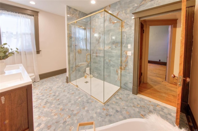 full bathroom with vanity, toilet, shower with separate bathtub, and hardwood / wood-style floors