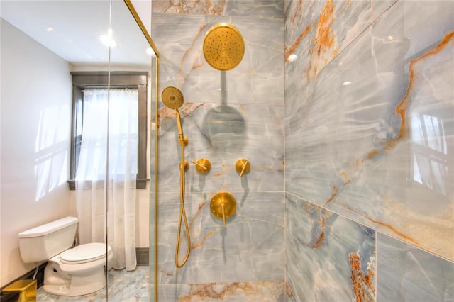 bathroom featuring toilet and tiled shower