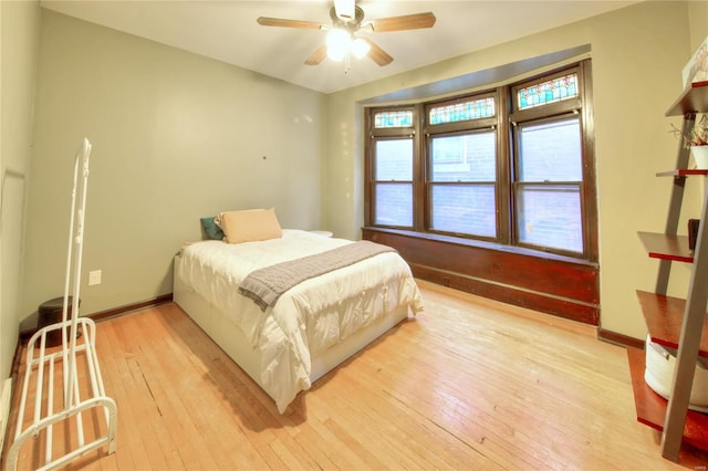 bedroom with light wood-type flooring and ceiling fan