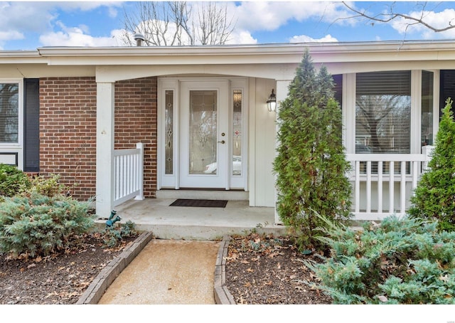 view of exterior entry featuring a porch