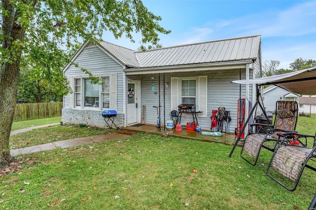 back of house with a lawn