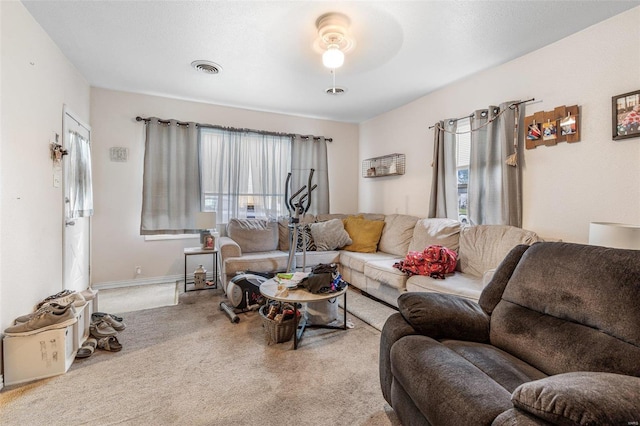 carpeted living room featuring ceiling fan