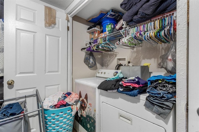 clothes washing area with washing machine and clothes dryer