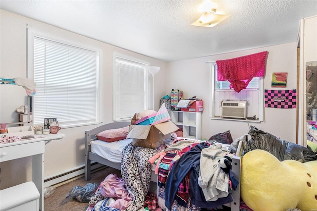 bedroom featuring cooling unit, multiple windows, carpet floors, and a textured ceiling