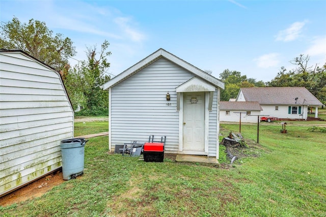 view of outdoor structure with a lawn