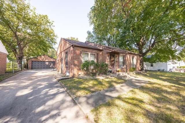 view of front of house featuring a front lawn, a garage, a porch, and an outdoor structure