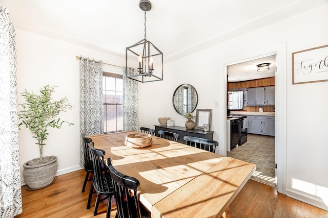 dining area featuring a chandelier and light hardwood / wood-style floors