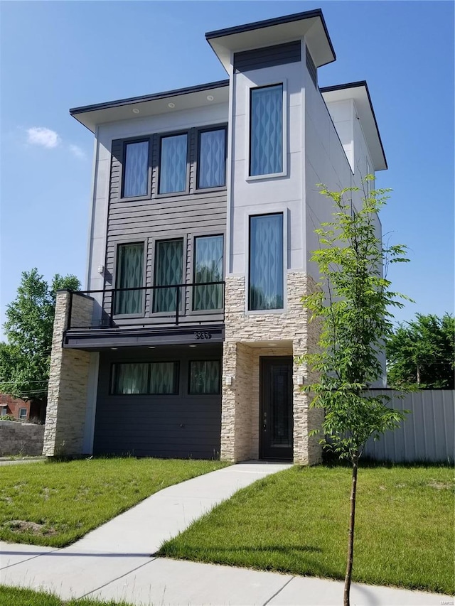 contemporary home with a balcony and a front lawn