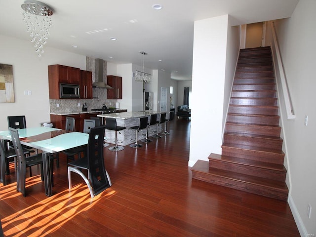 dining room with an inviting chandelier and dark hardwood / wood-style flooring