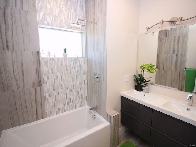 bathroom with tiled shower / bath, vanity, and hardwood / wood-style flooring