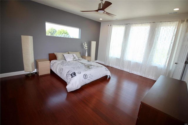 bedroom with ceiling fan and dark hardwood / wood-style floors