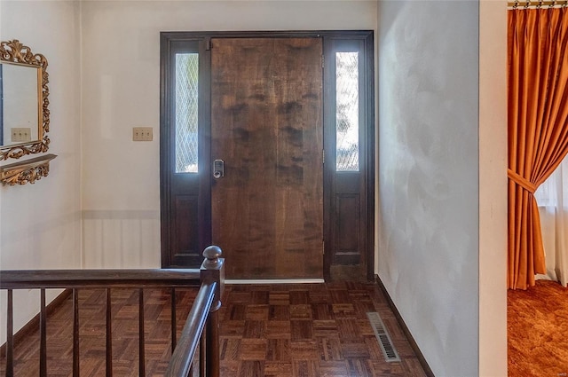 foyer entrance with dark parquet flooring